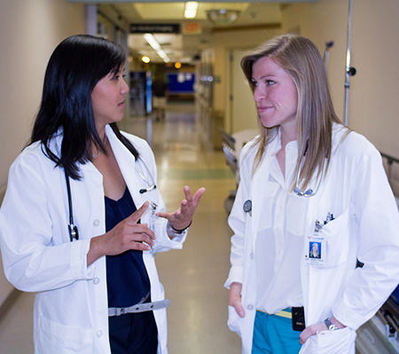 L-R: Emergency Medicine residents Margaret Zhang and Jess Paul, in the corridors of Royal Columbian Hospital in New Westminster. Photo credit: Daniel Presnell