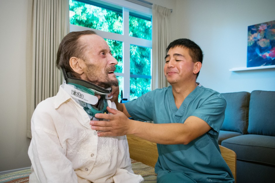 Norberto Bunagan assists a patient at the St. John Hospice. Photo: Martin Dee