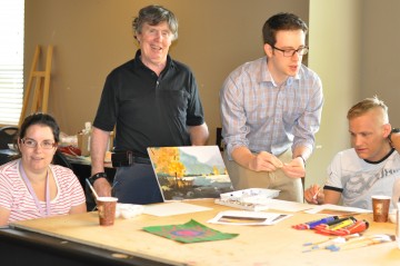 Medical student Maksim Parfyonov, second from right, leads the weekly art class with Connect residents Amadee Hollowink, Glen O’Connor, and Matthew McKay.