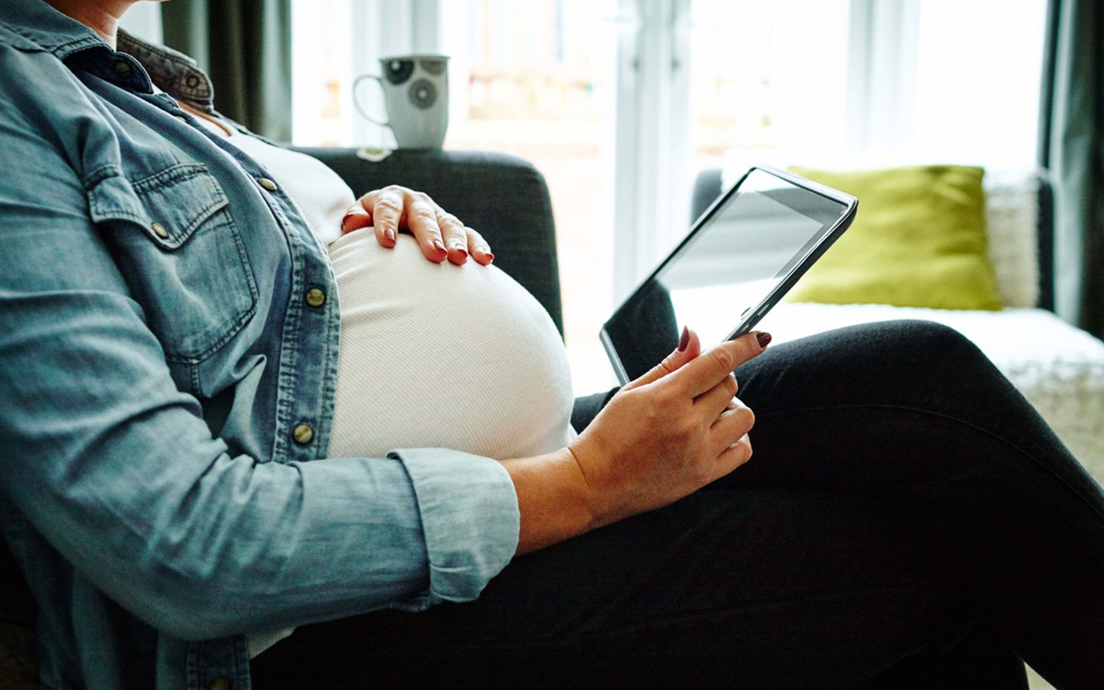 Pregnant woman using a tablet device