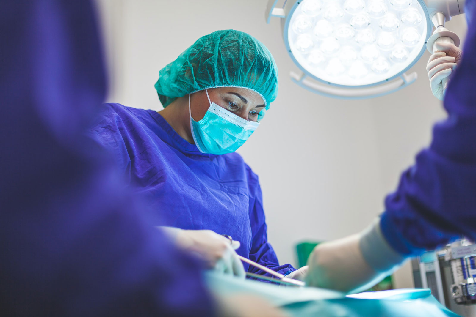 Healthcare worker in scrubs attending a surgery