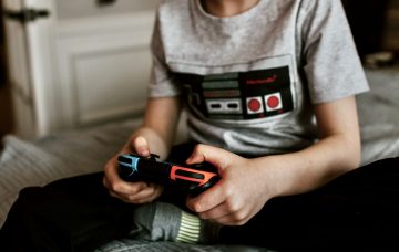 Photo of a child playing video games. Video games can trigger deadly heart rhythms in at-risk kids