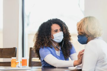 Image of female nurse listening to a female patient's heart. Diet and lifestyle education in a family practice clinic can benefit wellbeing.