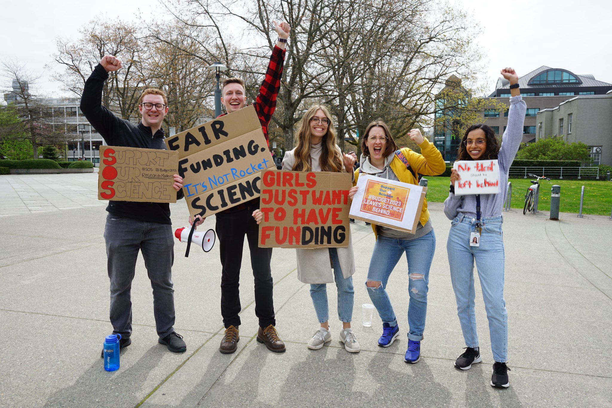 A group of five UBC graduate students and postdoctoral researchers hold signs at the Support Our Science walkout at UBC’s Vancouver campus.