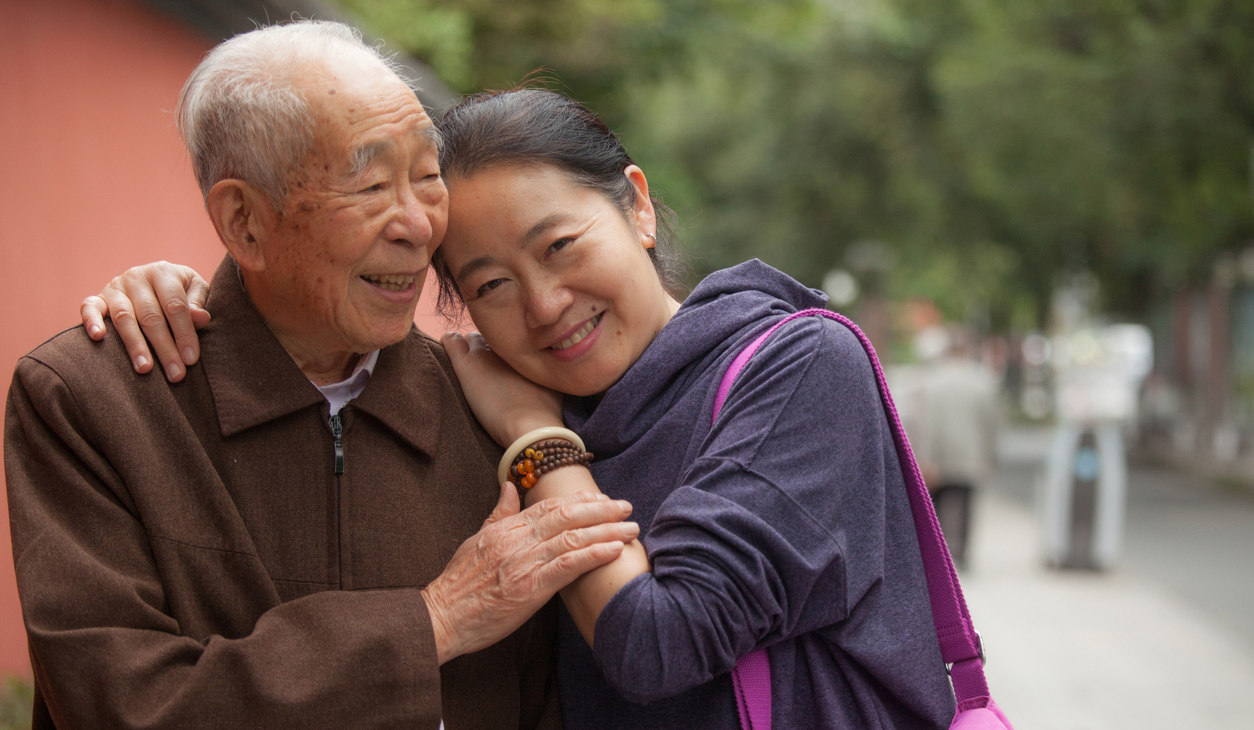 90 year old Chines man sharing a tender moment with his adult daughter