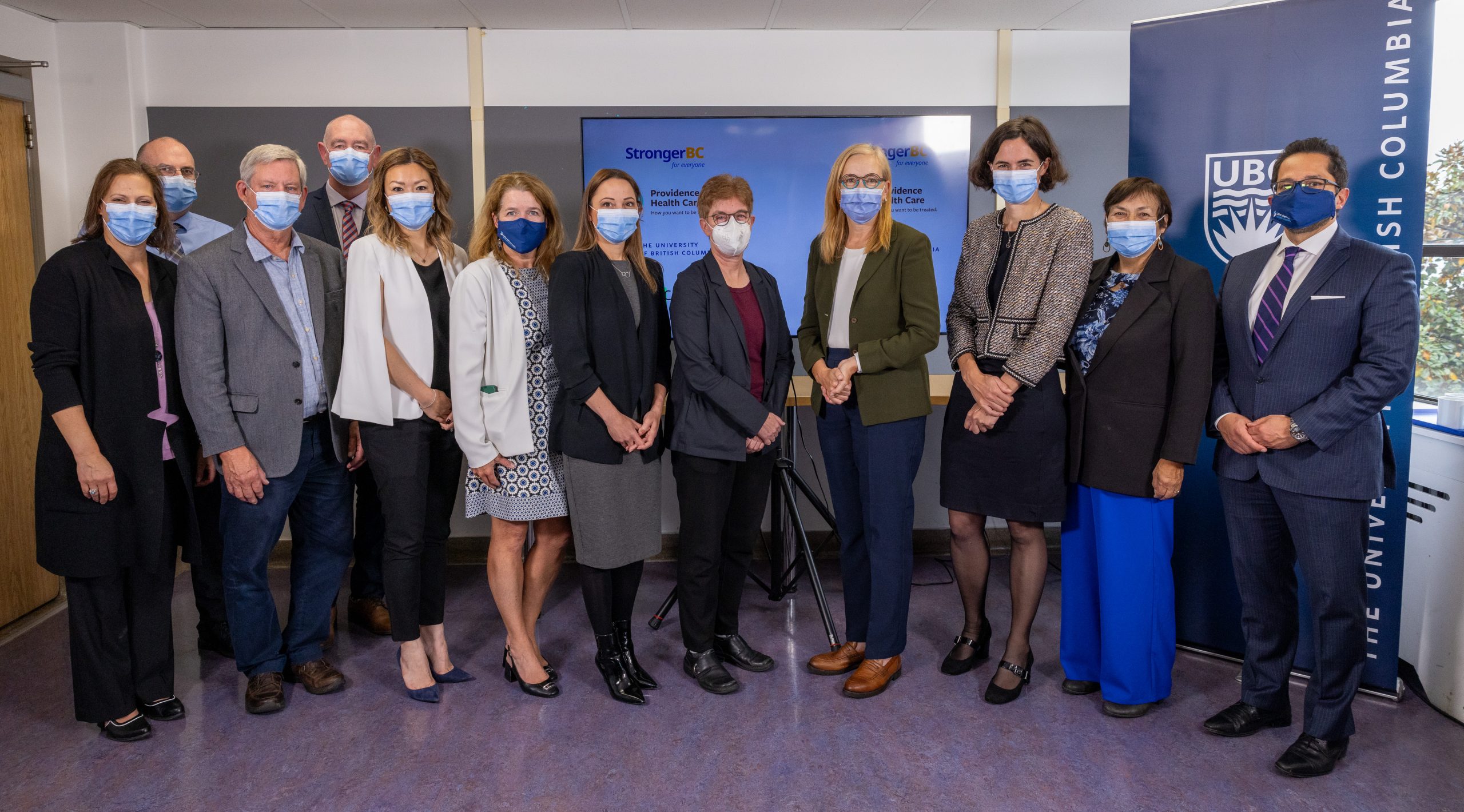 The Honourable Brenda Bailey (fourth from right) joined by members of B.C.’s life sciences community at the clinical trials announcement, including UBC’s Dr. Gail Murphy (fifth from right), Dr. Robert McMaster (third from left) and Dr. Michelle Wong (fifth from left).